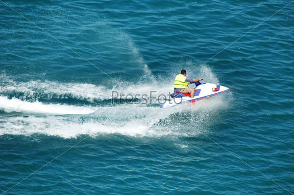 Man driving a motorised scooter at sea