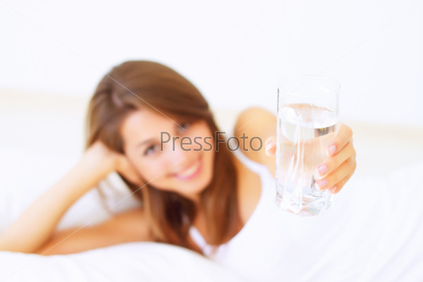 Beautiful girl handed a glass of water