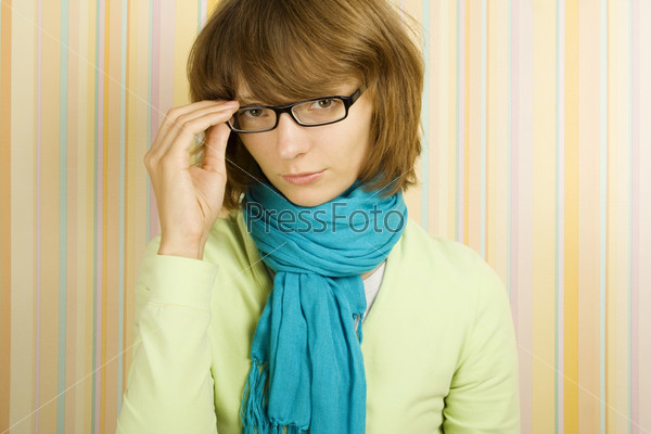Beautiful young woman in glasses. Correcting glasses
