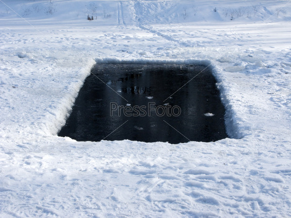 Ice-hole in frozen lake