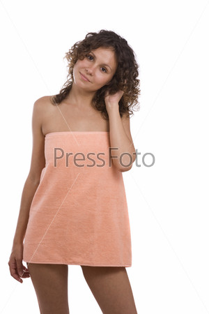 Woman wrapped in a peach-coloured bath towel. Sexy girl wearing towel.  Isolated on a white background in studio.Young Woman in Bath series Girl in the towel after massage, spa and wellbeing concept.