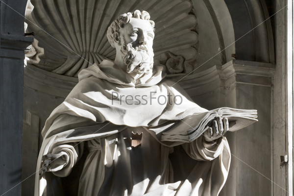 sculpture in a niche on the wall inside St. Peter\'s Basilica in Rome, Italy.