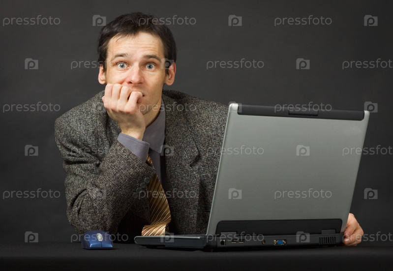Surprised person with computer. Sits and thinks.