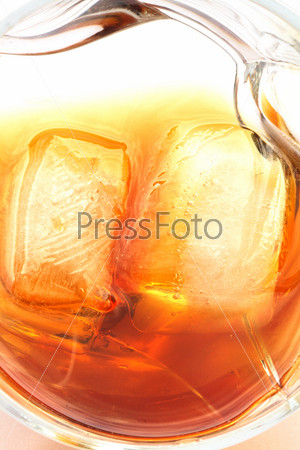 Closeup of whiskey with ice cubes on white background