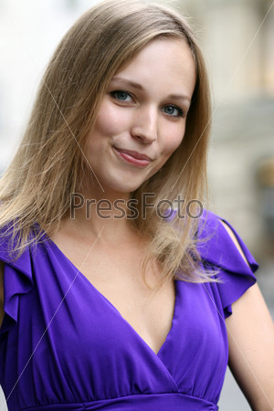 Portrait of a young woman smiling on urban background
