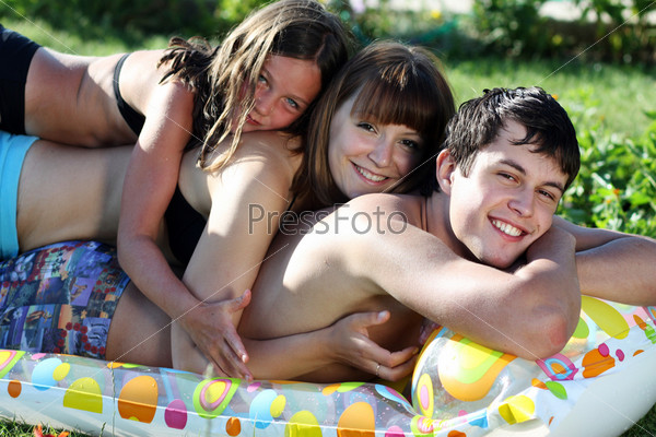 Young family from three person lay on an inflatable mattress