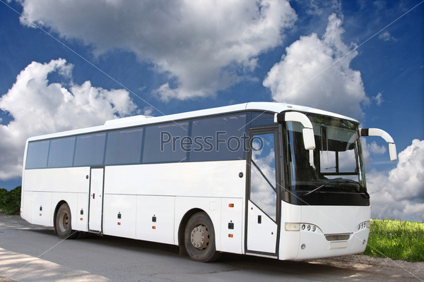 The white excursion bus against the blue sky, stock photo