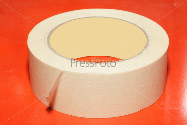 Sticky tape under the red background, stock photo
