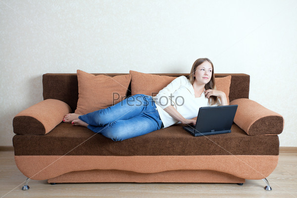 Woman with laptop on the sofa