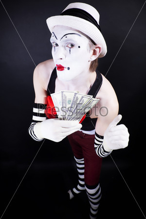 funny mime in white hat and gloves, holding a stack of hundred-dollar bills