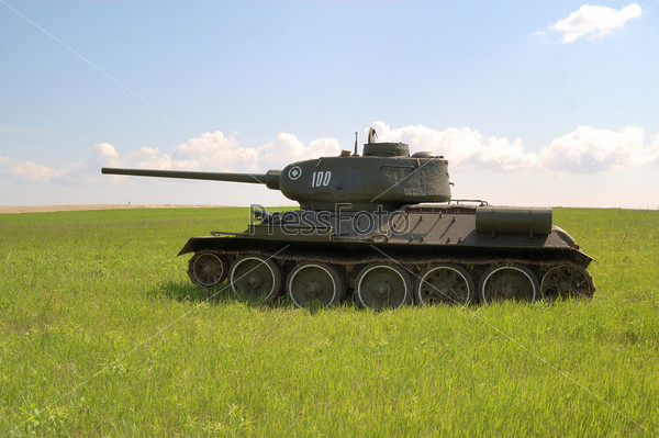 Old Soviet tank T-34 of World War II,  running on the grass field;