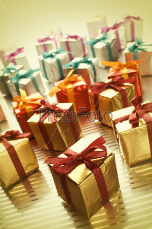 Lots of colorful gift boxes tied with ribbons. A gift for Christmas, Birthday, Wedding, or Valentine\'s day. Yellow tint