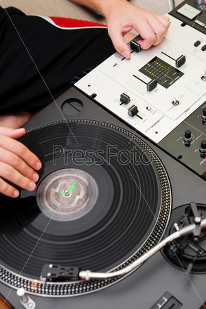 Hand of a disc jockey on the professional mixing controller