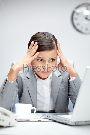 Image of young employer looking at laptop with troubled expression