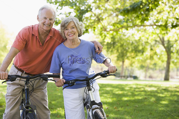 Senior couple on cycle ride in countryside, stock photo
