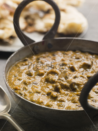Close up of Kali Dahl Served in a Karahi With Naan Bread