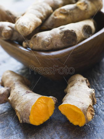 Pieces of Whole And Cracked Fresh Turmeric Root