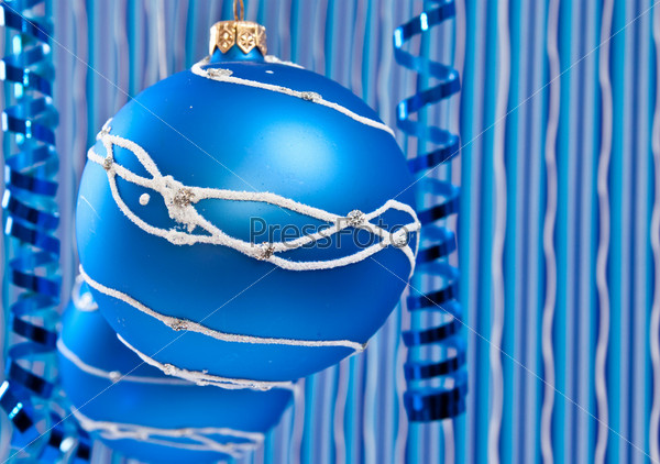 Christmas decoration from two blue balls on blue background, stock photo
