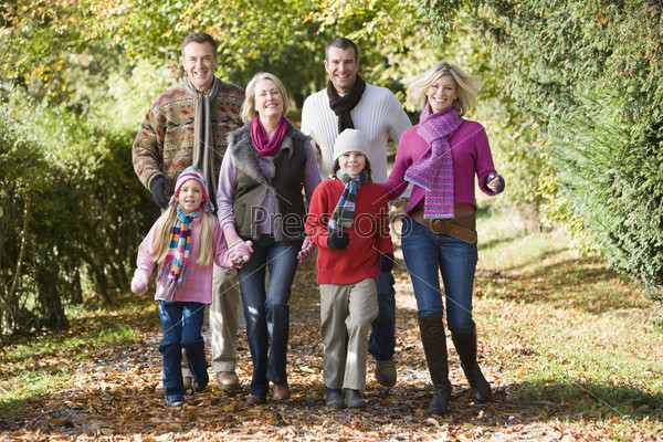 Multi-generation family on walk through autumn woods