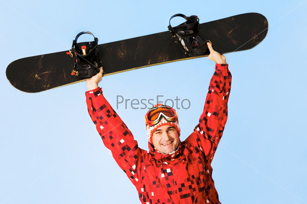 Portrait of happy man with skateboard looking at camera and smiling