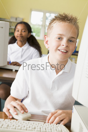 Student at computer terminal with student in background