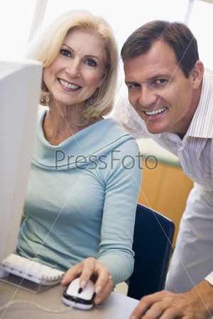 Man and woman at computer smiling (high key)