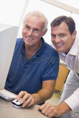 Mature male student learning computer skills