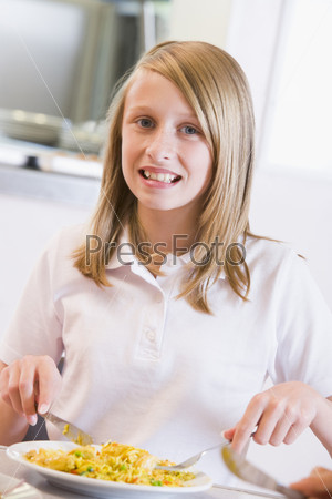 Student in cafeteria eating lunch