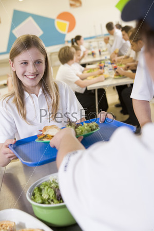 A student collecting lunch in school cafeteria