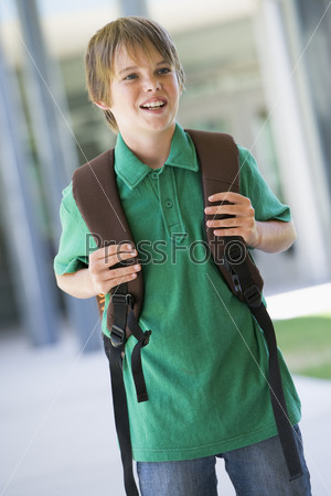 Elementary school pupil outside with rucksack