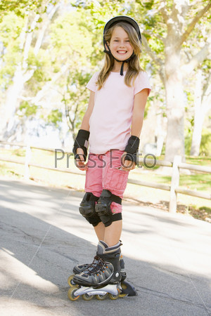 Young Girl Outdoors On Inline Skates Smiling