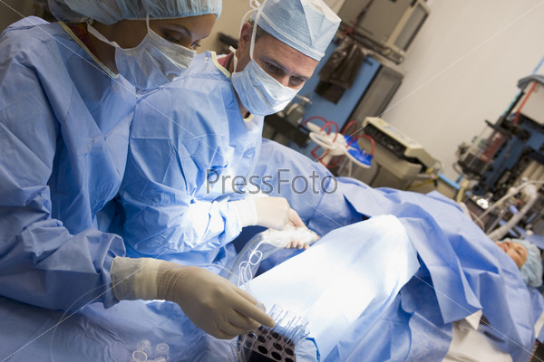 Woman in operating room undergoing egg retrieval procedure