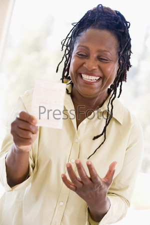 Stock Image of Woman with winning lottery ticket excited and smiling