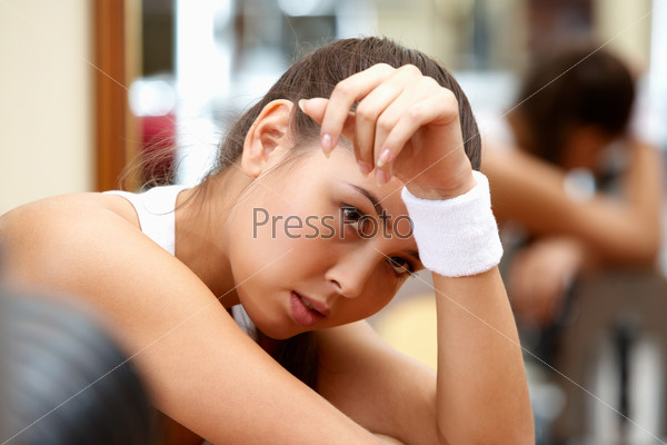 Portrait of tired brunette having rest in short break after workout, stock photo