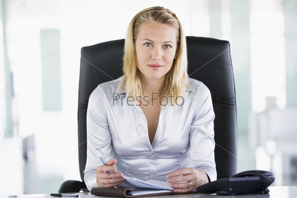 Businesswoman sitting in office with personal organizer
