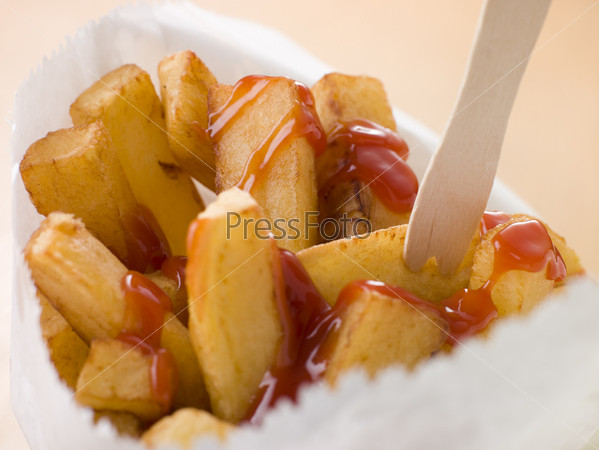 Chip Shop Chips in a Bag with a Wooden Fork and Tomato ketchup