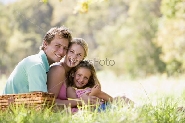 Family at park having a picnic and laughing