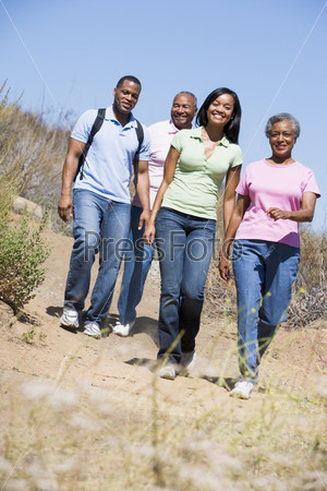 Two couples walking on path smiling