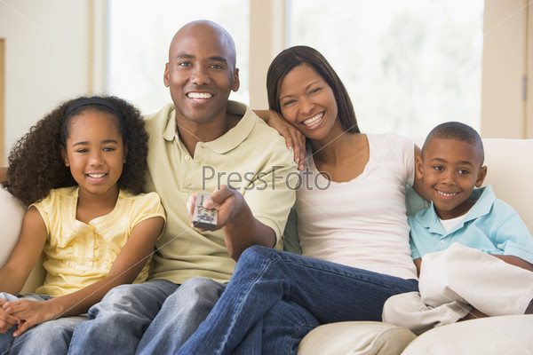 family relaxing watching television at home