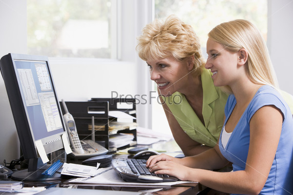 mother and daughter using home computer