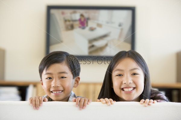 Two young children in room with flat screen