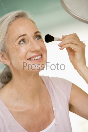 Woman with makeup brush