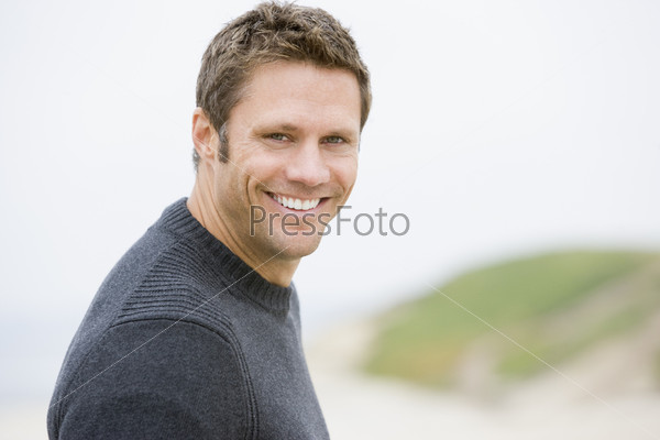 Man standing at beach smiling