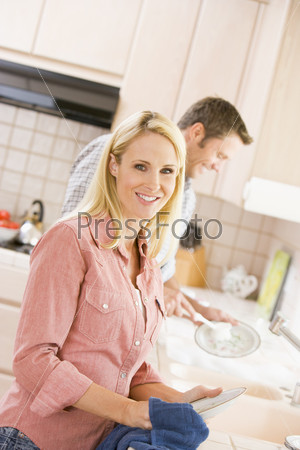 Husband And Wife Doing Dishes