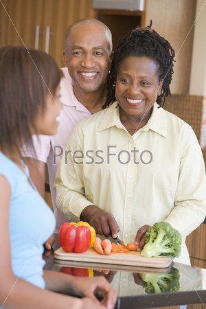 Couple With Daughter Preparing meal, mealtime
