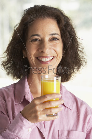 Middle Aged Woman Drinking Fresh Orange Juice