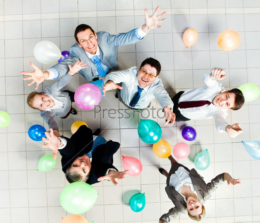 Above view of joyful business people with balloons in air and on the floor