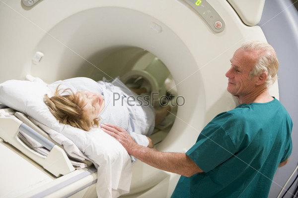 Doctor With Patient As They Have CAT Scan