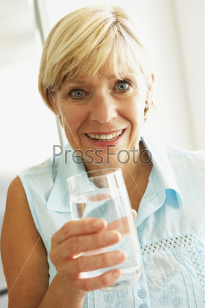 Middle Aged Woman Drinking A Glass Of Water