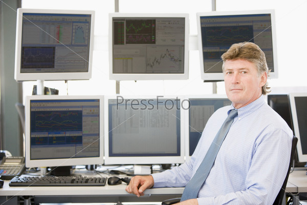 Portrait Of Stock Trader In Front Of Computer Monitors